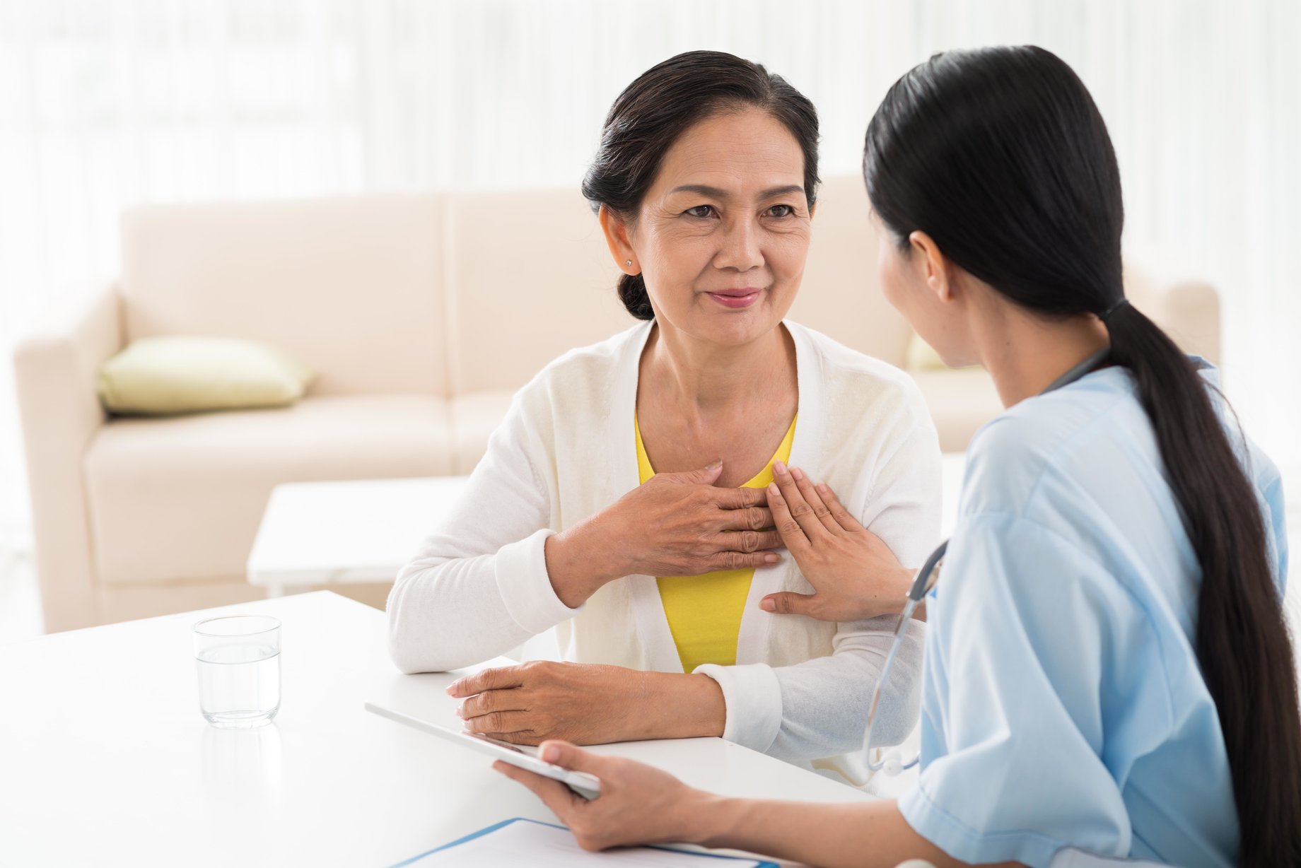 An older adult patient under the care of a young female doctor