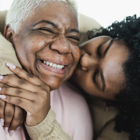 Older adult hugging caregiver