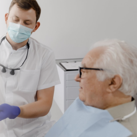 Older adult male at a dentist appointment with make dentist